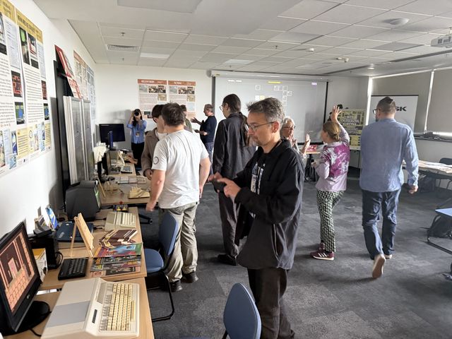 Visitors exploring the “Bits Behind the Curtain” exhibition at NASK.